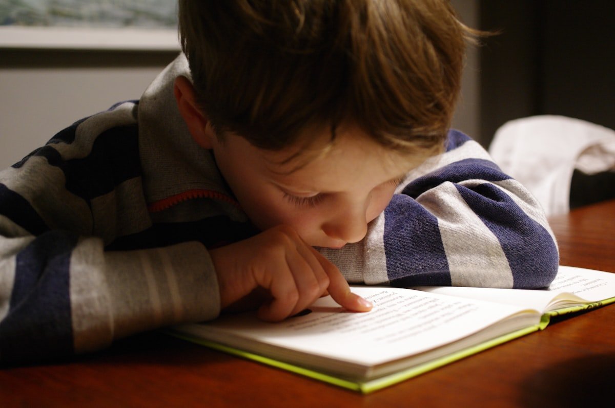 Child reading a book during Learning Lane class