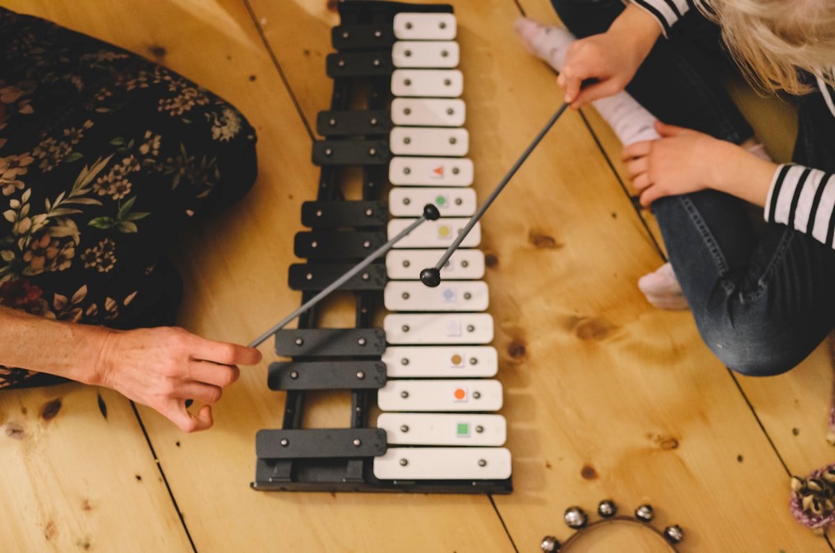 Child playing a musical instrument during Rhythm Road class