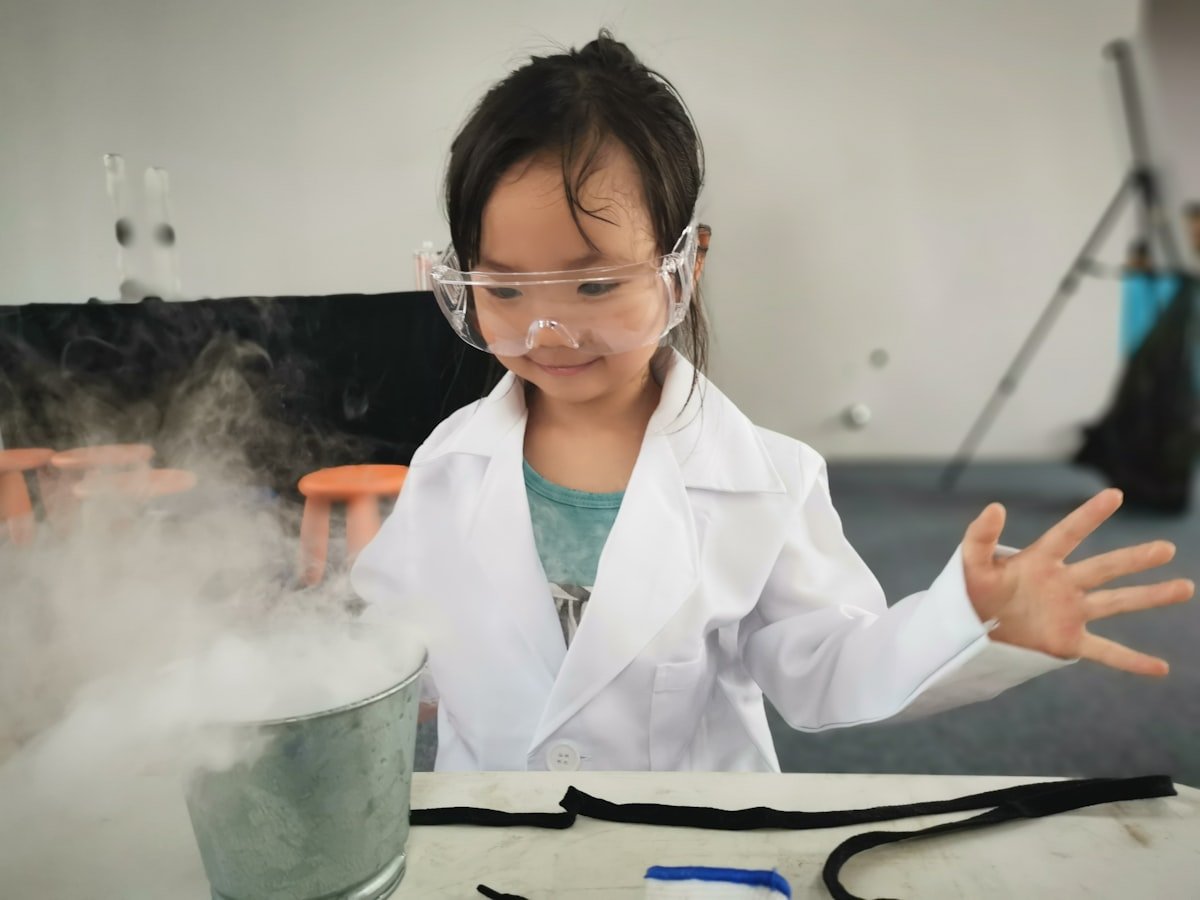 Child doing a science experiment during STEM Square class